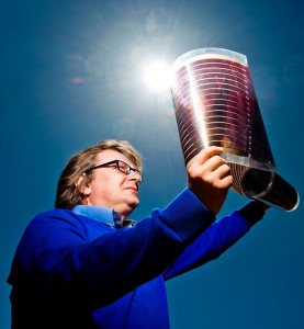 Prof. Eugene Katz displaying flexible photovoltaic surfaces