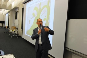 Prof. Dubinsky at the closing ceremony of Innovation Workshop 2016, holding the glass stela, and Dr. Seuss in the background.