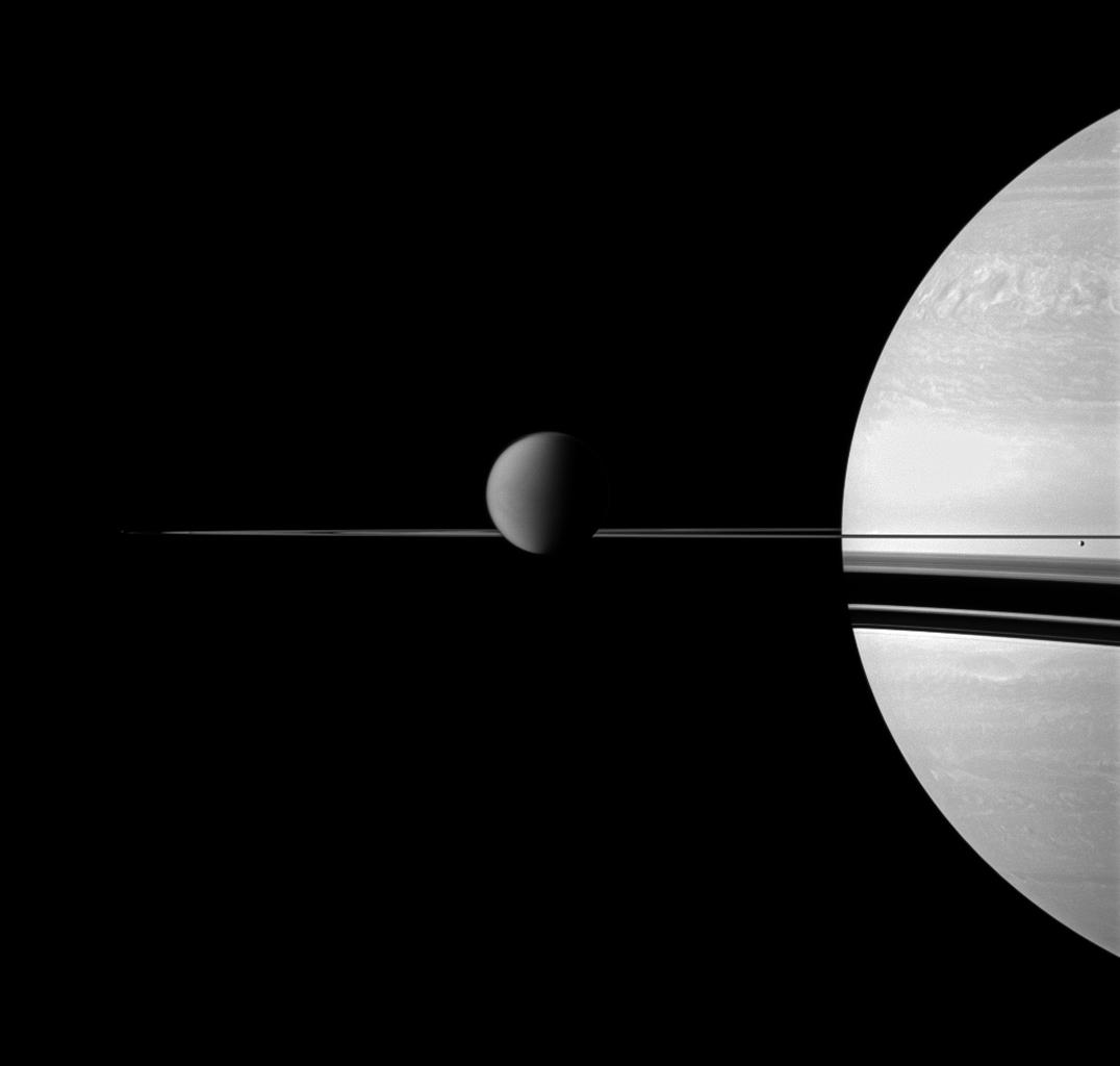 A depiction of Titan with Saturn in the background. Image: NASA/JPL/Space Science Institute.