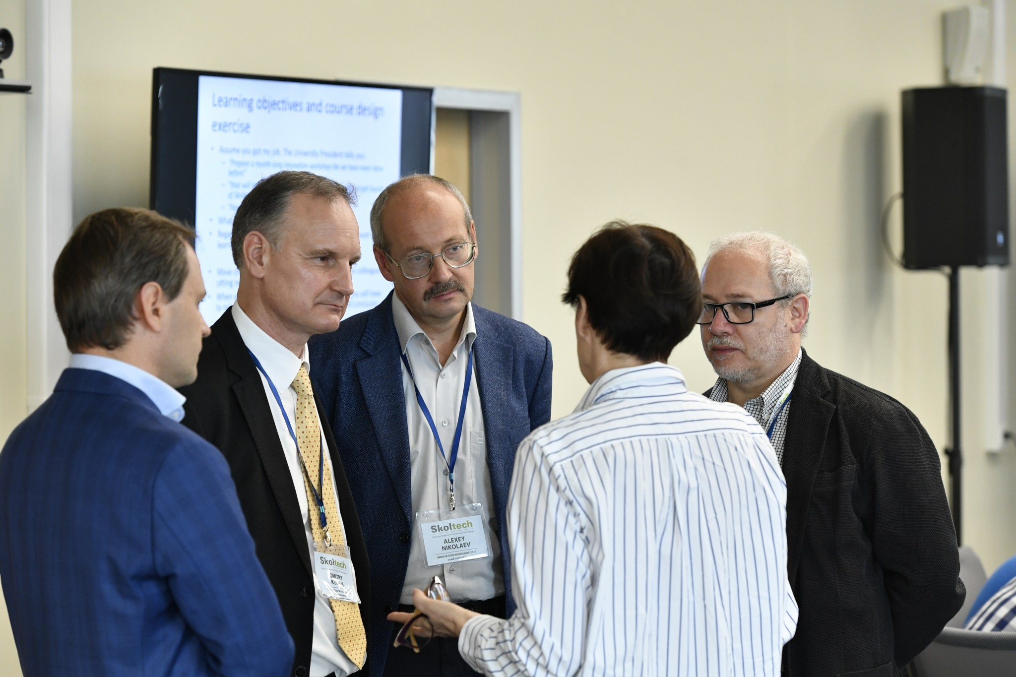 Skoltech professors and IW faculty advisors, from left, Pavel Dorozhkin, Dmitry Kulish, Alexey Nikolaev and Maxim Kiselev, huddle. Photo: Skoltech.