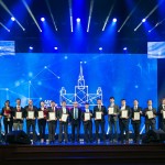 Young scientists, including four Skoltech employees, pose with their prizes on the stage of the State Kremlin Palace.