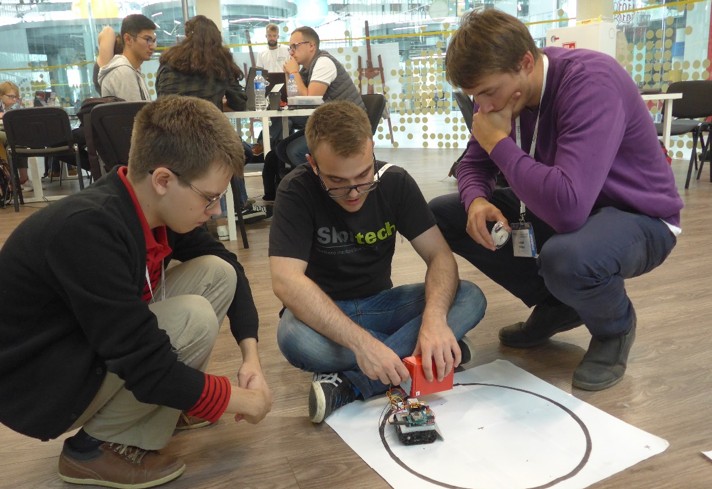 Students prepare a self-driving inventory robot for the Innovation Workshop’s Internet of Things (IoT) exercise.