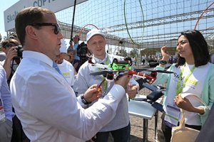 PM Medvedev receives a quadrocopter built by the Skoltech Student Engineering Club. Image courtesy RIA-Novosty