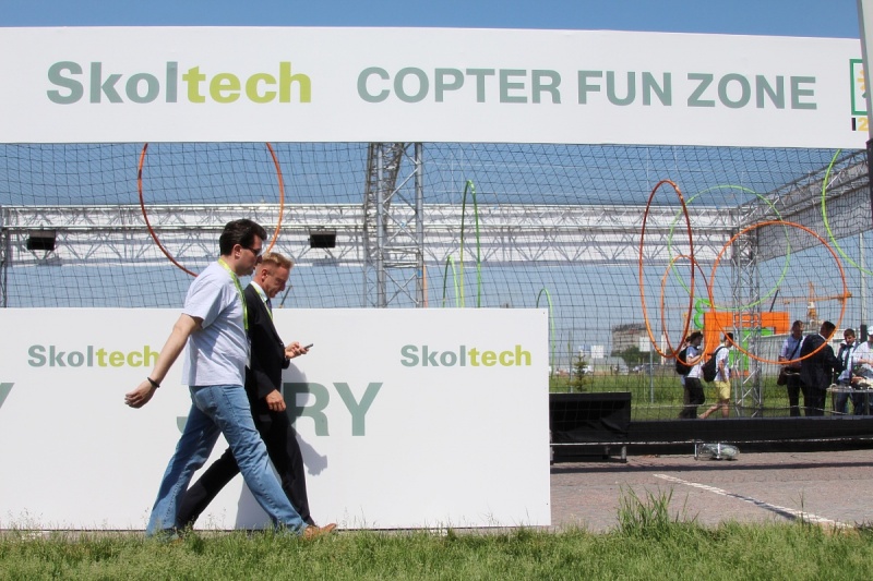 Russian Minister of Education and Science Dmitry Livanov and Alexei Sitnikov, Skoltech VP of Institutional and Resource Development walking past copter arena