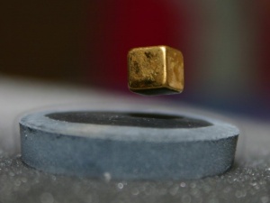 A cubical magnet levitating over a superconducting material. Image courtesy of Wikipedia, under Creative Commons license