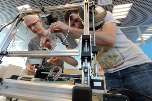 At the Skoltech composite lab, senior research scientist Fedor Antonov (right) and Mikhail Golubev, a design engineer,  operate a 3D printer which produces a stiff and resilient composite material. The Moscow based team of researchers now aims to register an international patent.