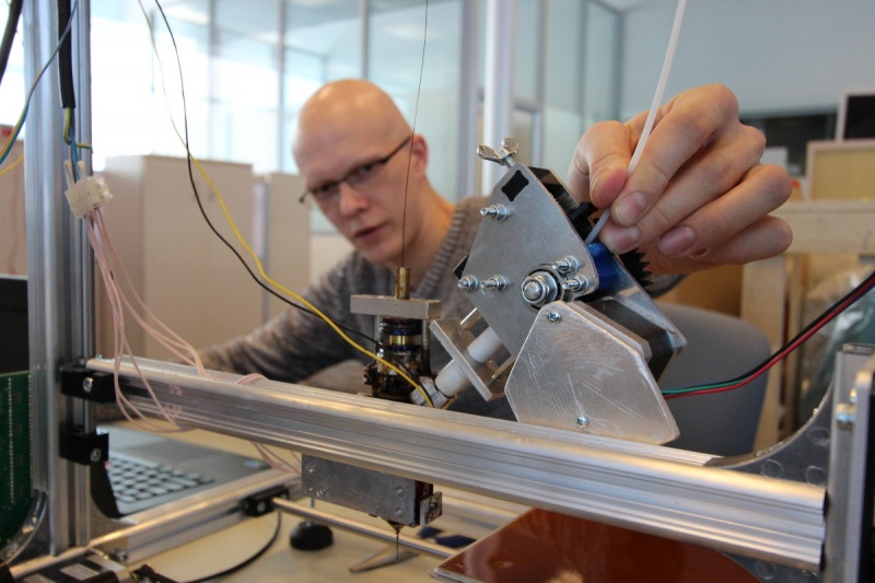Mikhail Golubev, a design engineer, operating and controlling a 3D printer at the university's composite materials lab.