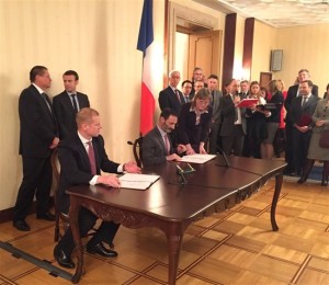 The agreement was signed by Nikolai Grachev, left, for Skolkovo, and Pierre de Firmas for EDF Group. Behind them, Alexei Ulyukaev, left, and his French counterpart Emmanuel Macron looked on.